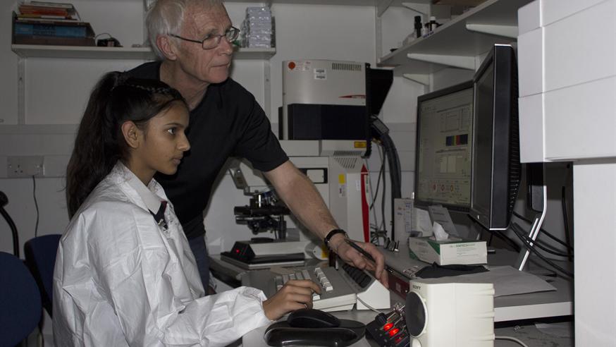 Student in lab being shown how to use equipment