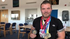 Hollywood Dave Griffiths with medals with marathon medals