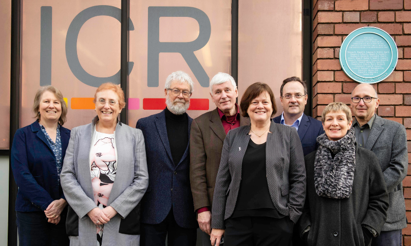 Scientists standing in front of blue plaque at the ICR