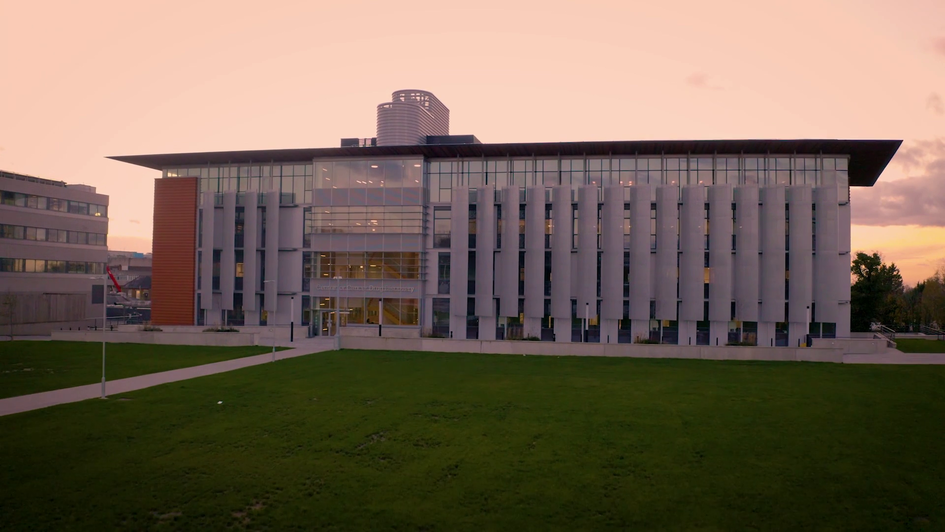 The Centre for Cancer Discovery pictured at sunset with a reddish sky in the background