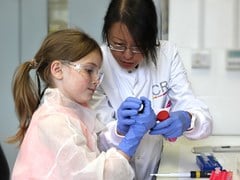 Dr Grace Mak with Maddie (teaching girl about science)