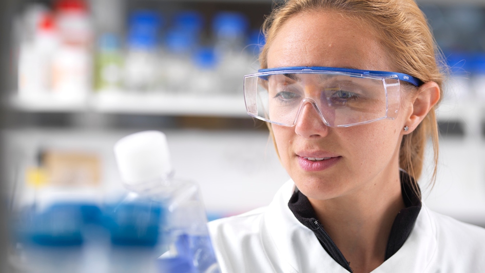 Female scientist in lab wearing safety goggles