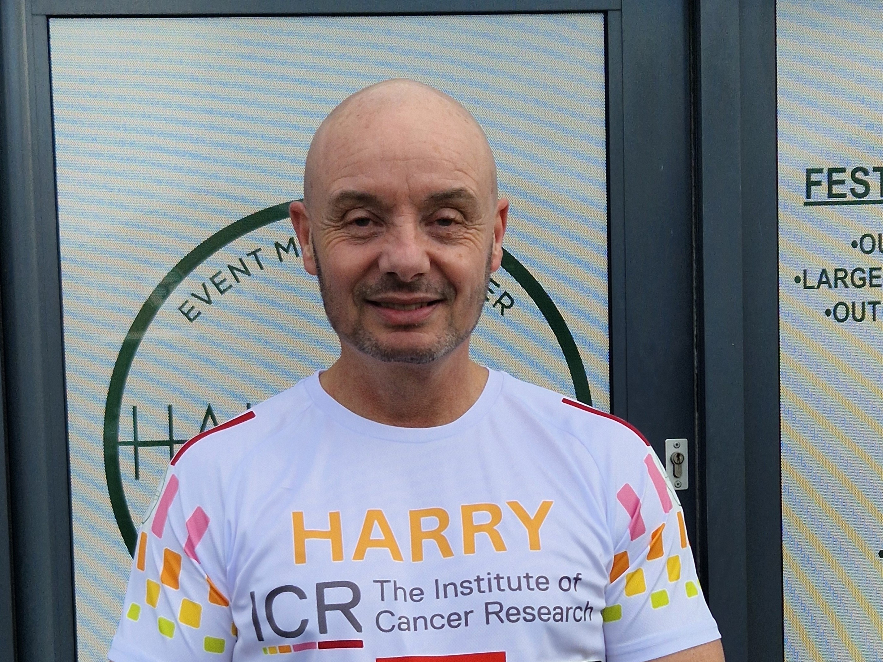 Harry wearing an ICR running vest, smiles for the camera