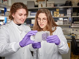 Two women in a lab looking at test results
