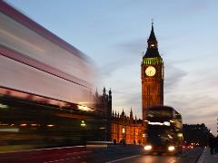 View of Big Ben and London buses at night