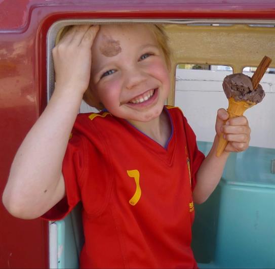 Lucas holding an ice cream and smiling