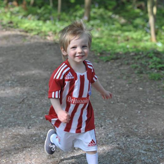 Lucas runs in his football kit