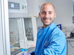 Marco Bezzi wearing a blue lab coat