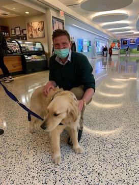 Dr Matthew Clarke pictured with a wellbeing dog, Rosalie, at St. Jude.
