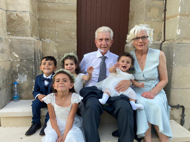 George with his wife and grandchildren.