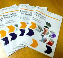 Three booklets of the ICR's research strategy arranged on a table