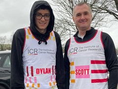 Dylan and Scott stand outside wearing their ICR vests and loo