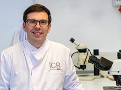 Stephen-John Sammut smiles in his ICR lab coat.
