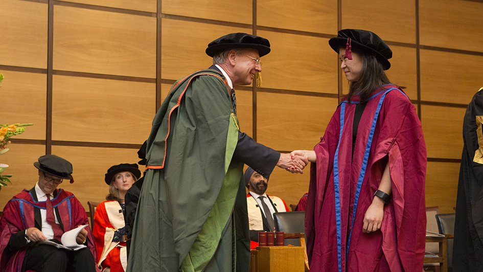 Student shaking hands with Paul Workman at ICR graduation