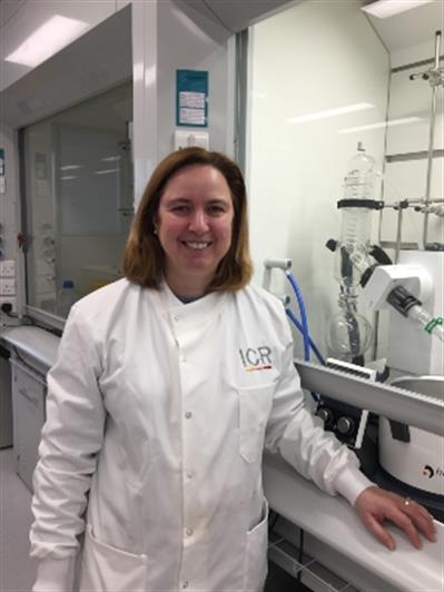 Tatiana McHardy standing in a lab wearing a white lab coat