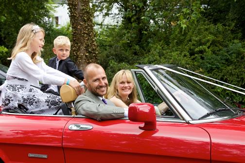 The Morgan family sat in a car at a wedding