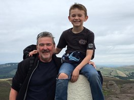 Tony and his grandson Ethan on top of a hill
