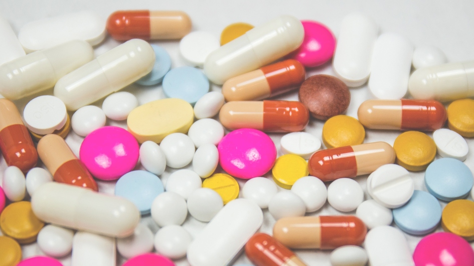 Assortment of multicoloured pills in a pile